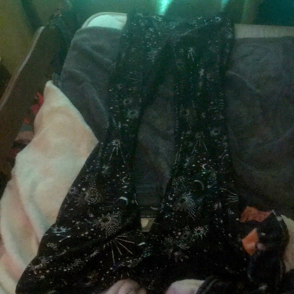 Black pair of flared leggings with suns, moons, and stars.
